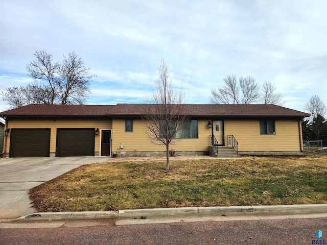 ranch-style home with a front lawn and a garage