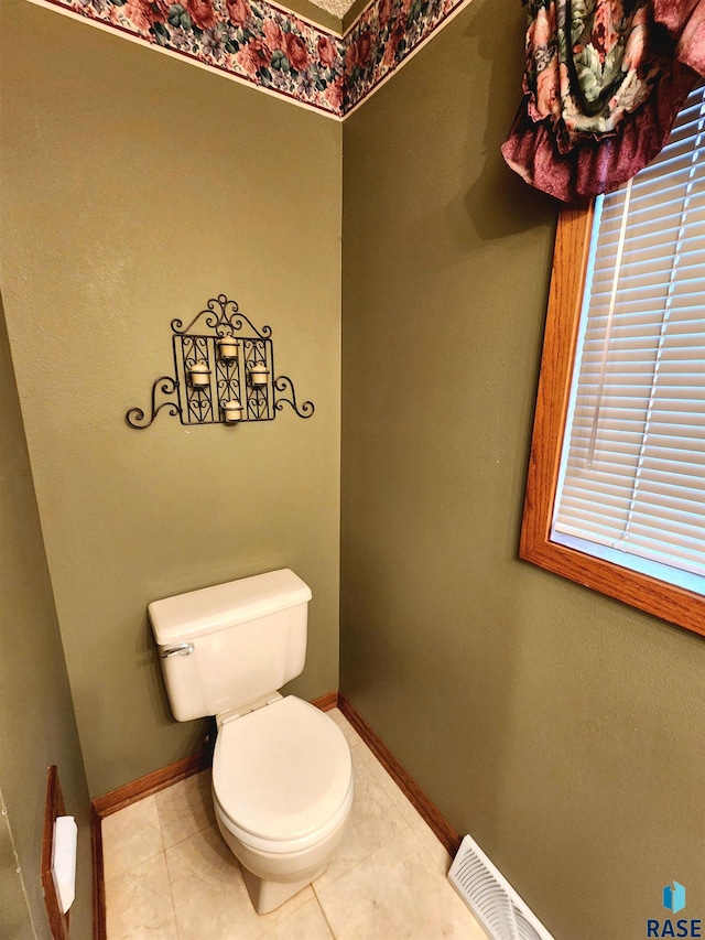 bathroom with tile patterned flooring and toilet
