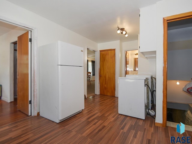 clothes washing area with dark hardwood / wood-style flooring and washer / clothes dryer