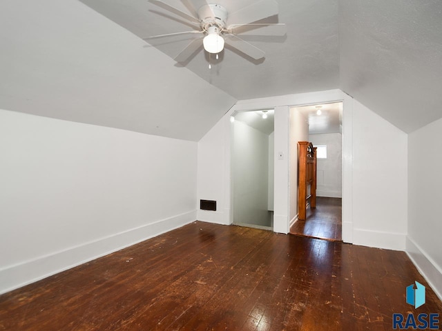 bonus room with ceiling fan, dark hardwood / wood-style flooring, and vaulted ceiling