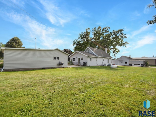 rear view of house featuring a lawn