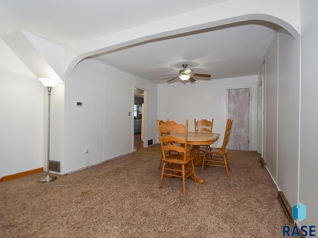 carpeted dining space featuring ceiling fan