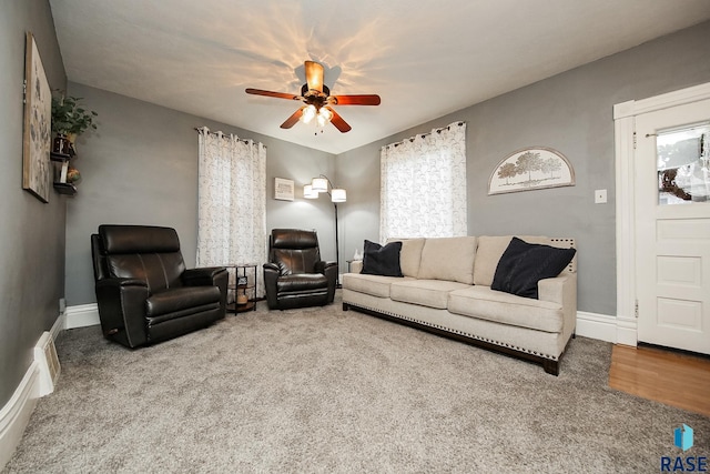 living room featuring carpet and ceiling fan