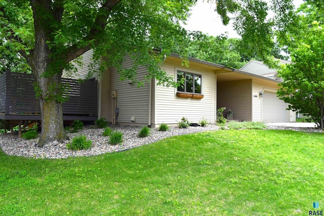 single story home with a garage and a front lawn