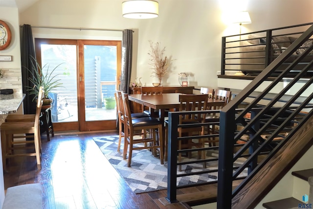 dining area featuring dark wood-type flooring