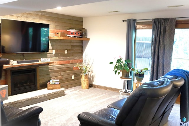 living room featuring carpet and wooden walls