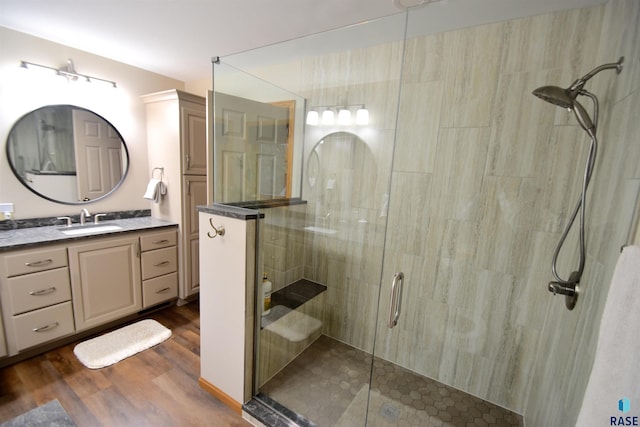 bathroom featuring vanity, wood-type flooring, and an enclosed shower