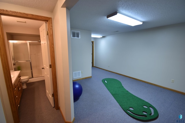 interior space featuring carpet flooring and a textured ceiling