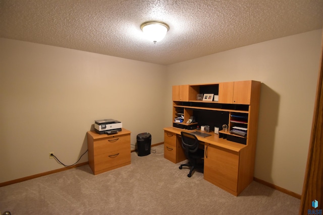 carpeted office space with a textured ceiling