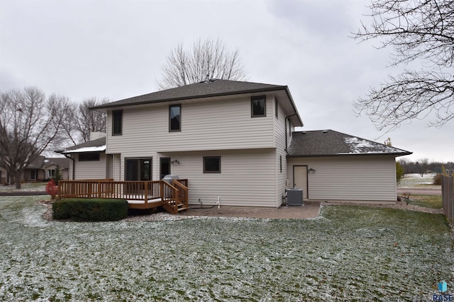 rear view of house with a wooden deck, a yard, and central AC