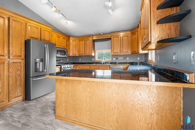 kitchen featuring kitchen peninsula, sink, stainless steel appliances, and lofted ceiling