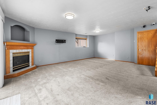 unfurnished living room with a fireplace and light colored carpet