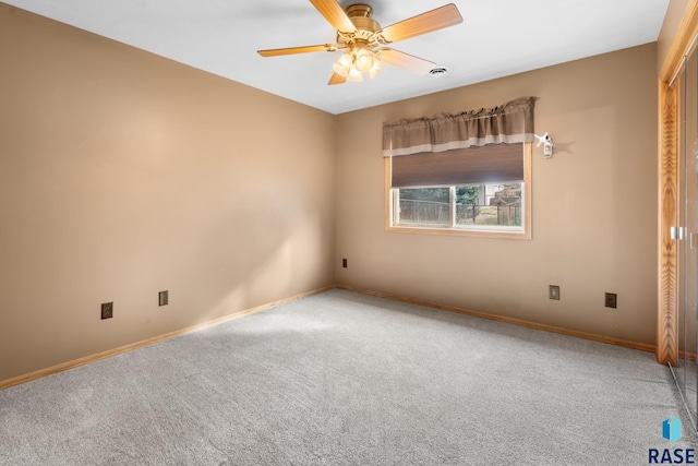 spare room with carpet and ceiling fan