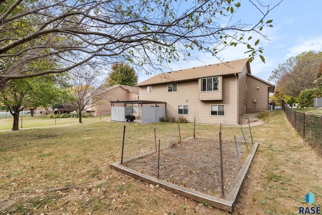 back of house featuring a yard