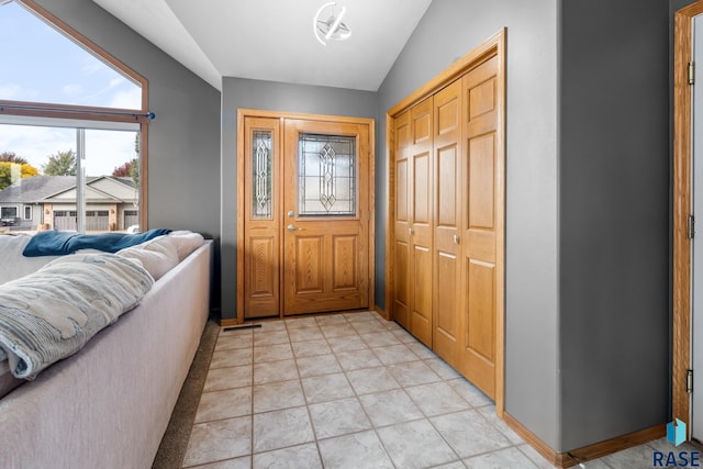 entrance foyer with light tile patterned flooring and lofted ceiling