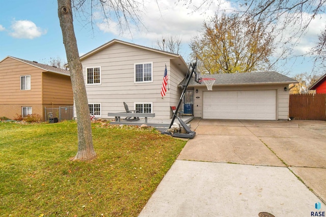 tri-level home with a garage and a front lawn