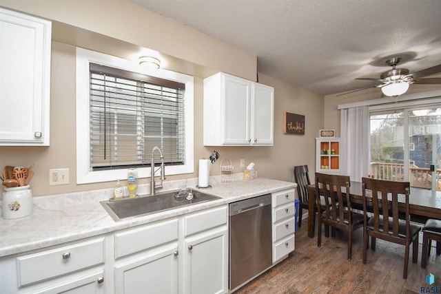 kitchen with stainless steel dishwasher, ceiling fan, sink, dark hardwood / wood-style floors, and white cabinetry