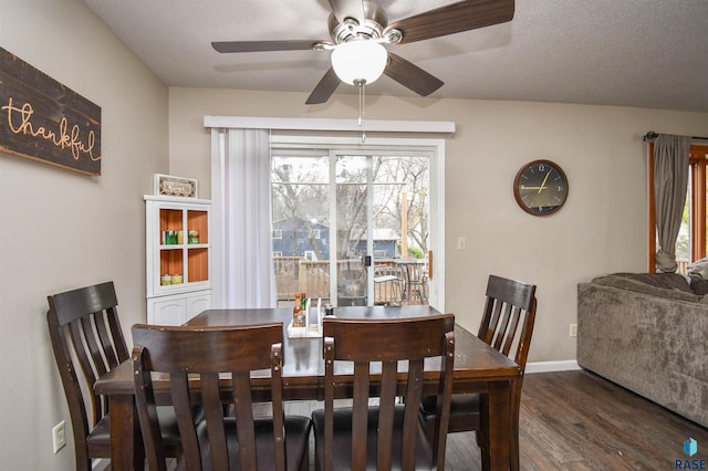 dining room featuring ceiling fan, a healthy amount of sunlight, dark hardwood / wood-style flooring, and a textured ceiling