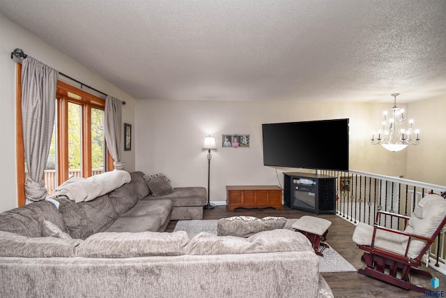 living room with a textured ceiling, dark hardwood / wood-style flooring, and a notable chandelier