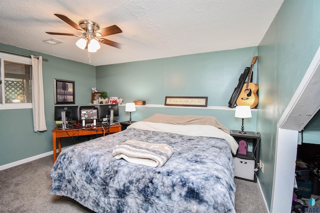 bedroom with a textured ceiling, carpet floors, and ceiling fan