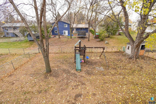 view of yard featuring a storage shed and a playground