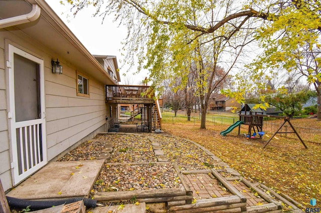 view of yard with a playground and a deck