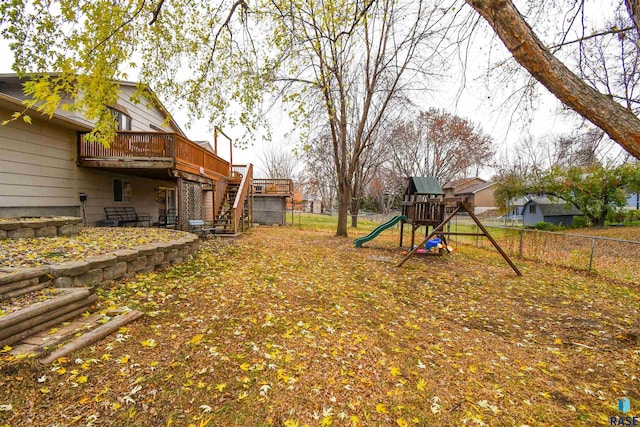 view of yard with a deck and a playground