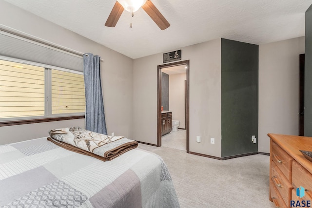 carpeted bedroom featuring connected bathroom, ceiling fan, and a textured ceiling