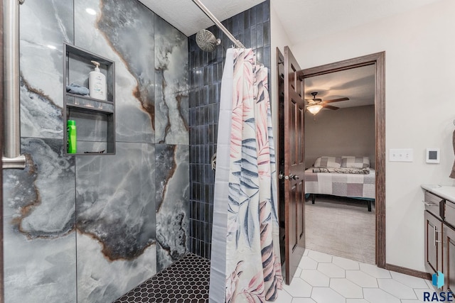 bathroom featuring a shower with shower curtain, vanity, ceiling fan, and tile patterned floors