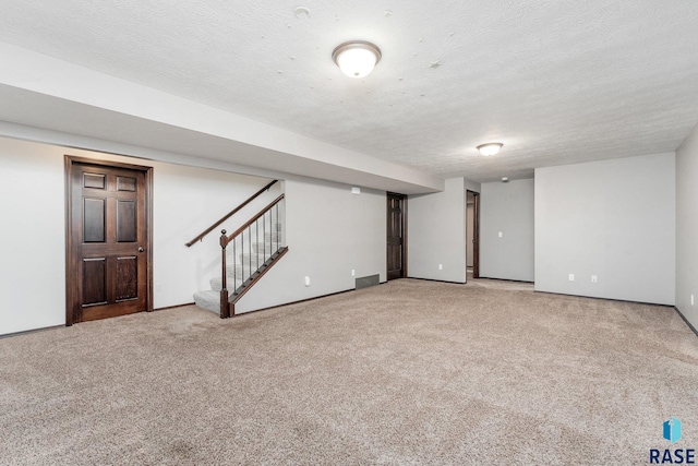 basement with carpet flooring and a textured ceiling