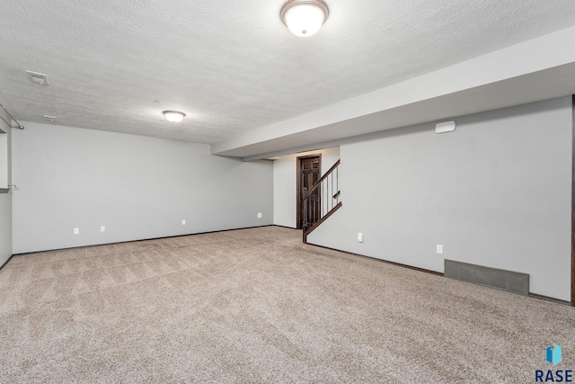 basement with carpet and a textured ceiling