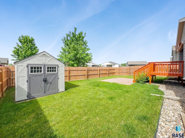 view of yard featuring a shed and a deck