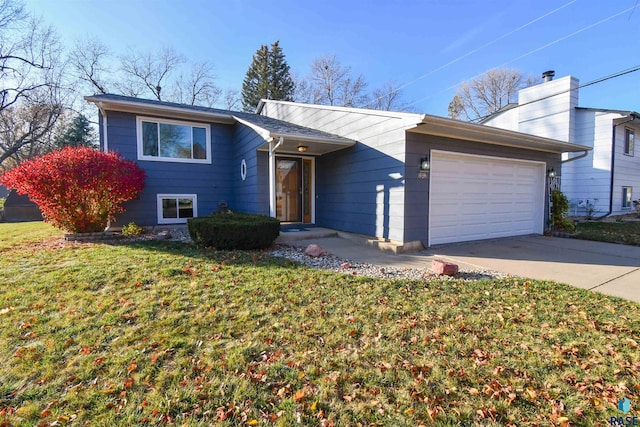 view of front of house featuring a garage and a front lawn