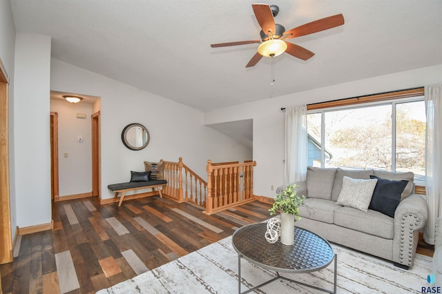 living room featuring dark hardwood / wood-style floors, ceiling fan, and lofted ceiling