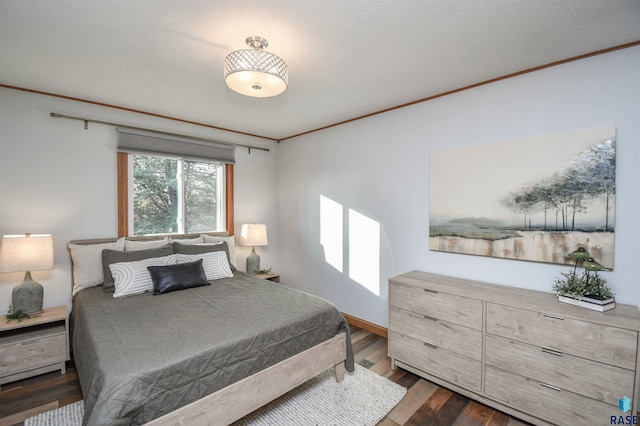 bedroom with a textured ceiling, dark hardwood / wood-style flooring, and crown molding