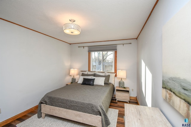 bedroom with hardwood / wood-style flooring, crown molding, and a textured ceiling