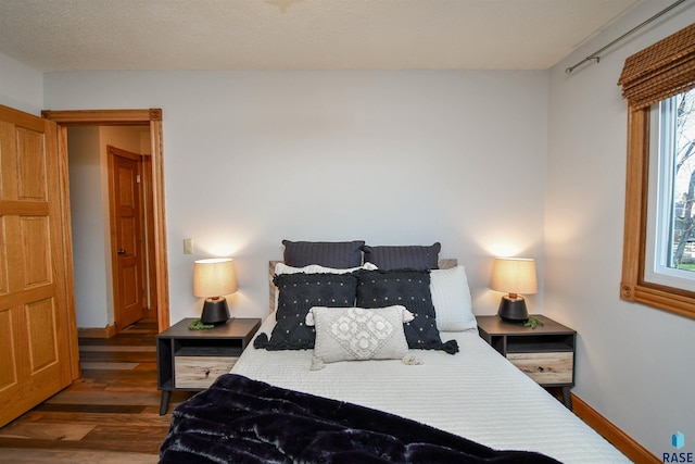 bedroom with dark wood-type flooring