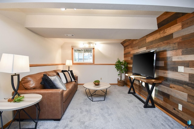 living room with light colored carpet and wooden walls