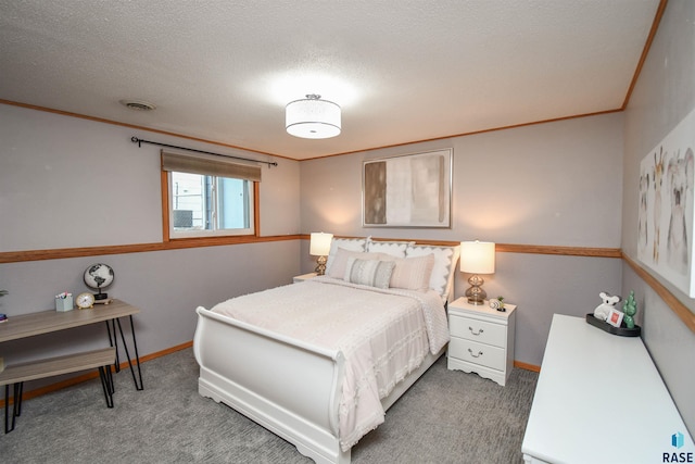 carpeted bedroom featuring a textured ceiling and crown molding