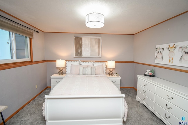 carpeted bedroom featuring a textured ceiling and crown molding