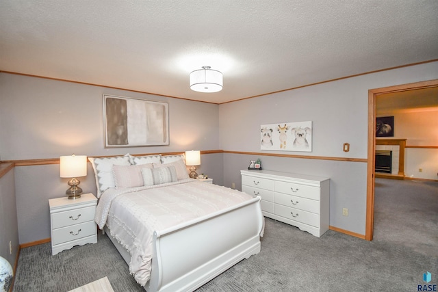 bedroom with carpet and a textured ceiling