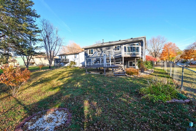 back of property featuring a yard and a wooden deck