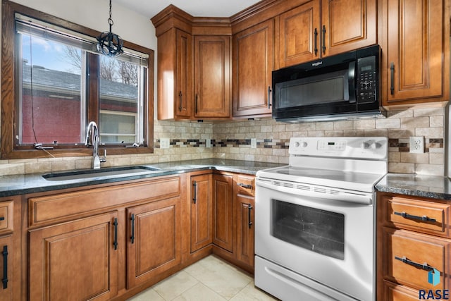 kitchen with dark stone counters, sink, electric range, light tile patterned floors, and tasteful backsplash