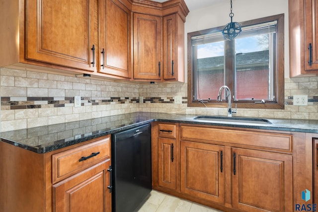 kitchen featuring dishwasher, sink, dark stone countertops, tasteful backsplash, and decorative light fixtures