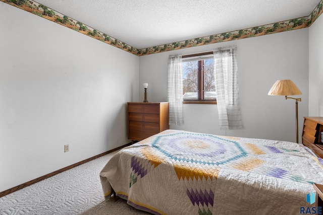 carpeted bedroom featuring a textured ceiling