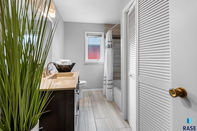 full bathroom featuring vanity, toilet, and shower / bathtub combination with curtain