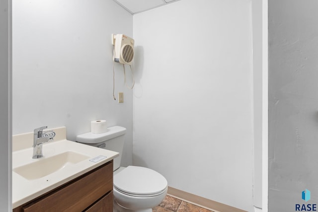 bathroom with tile patterned flooring, vanity, and toilet