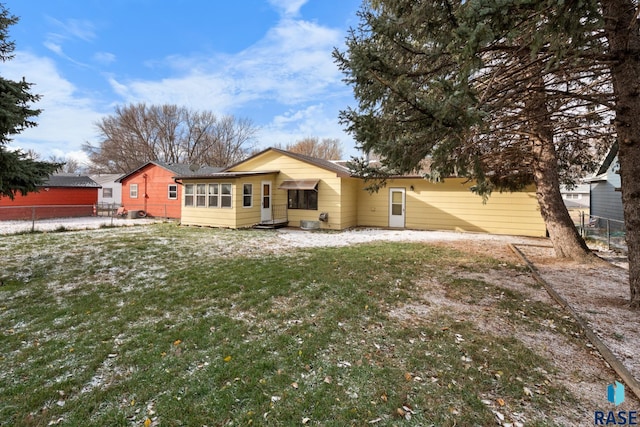 rear view of property with a yard