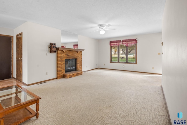 carpeted living room featuring a textured ceiling, ceiling fan, and a fireplace