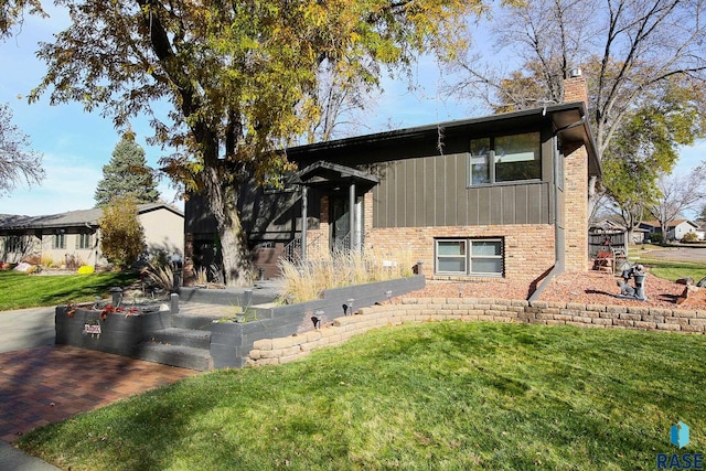 view of side of property with a lawn